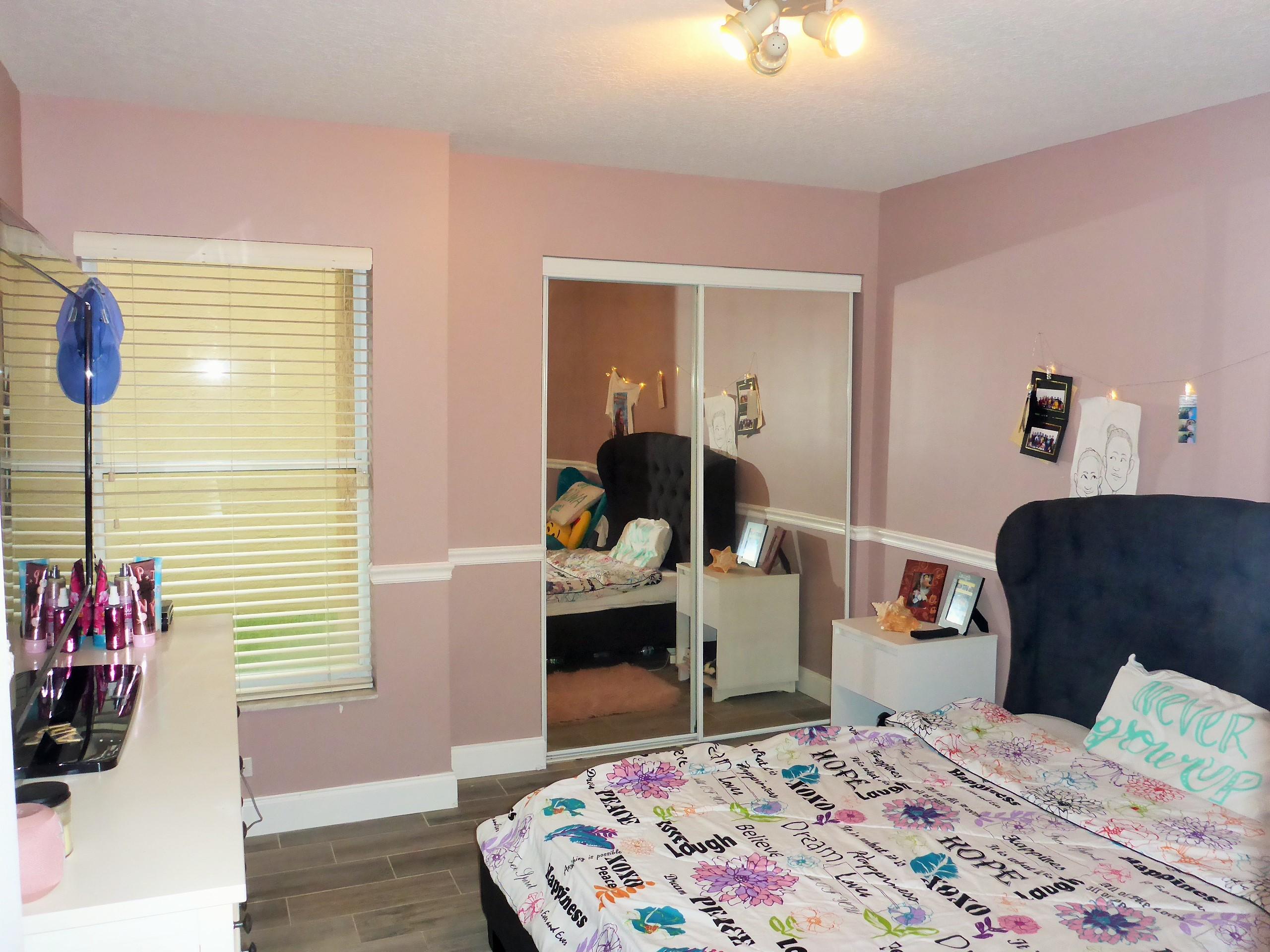 5009 Elpine Way Riviera Beach, FL 33418 - Photo 25 of 41 a bedroom with a bed and wooden floor