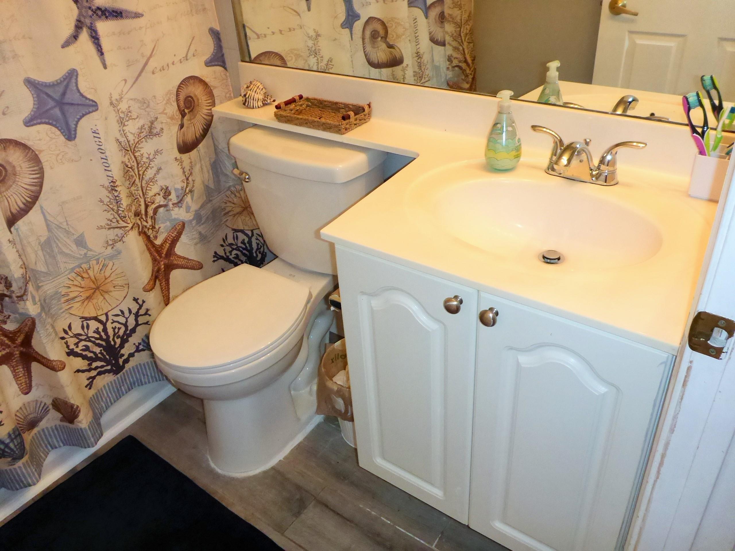 5009 Elpine Way Riviera Beach, FL 33418 - Photo 29 of 41 a bathroom with a sink and a toilet