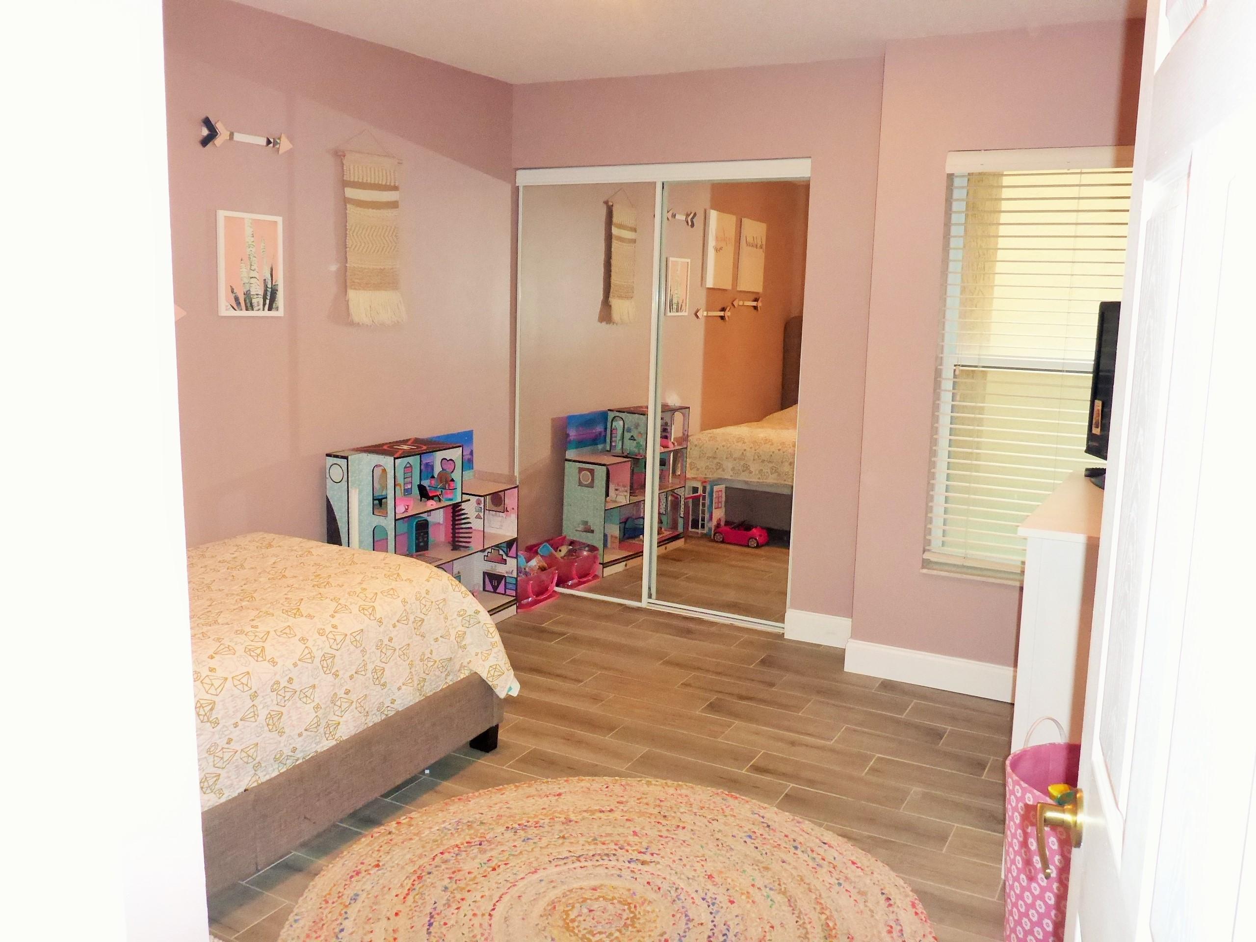 5009 Elpine Way Riviera Beach, FL 33418 - Photo 30 of 41 a bedroom with a bed and a window