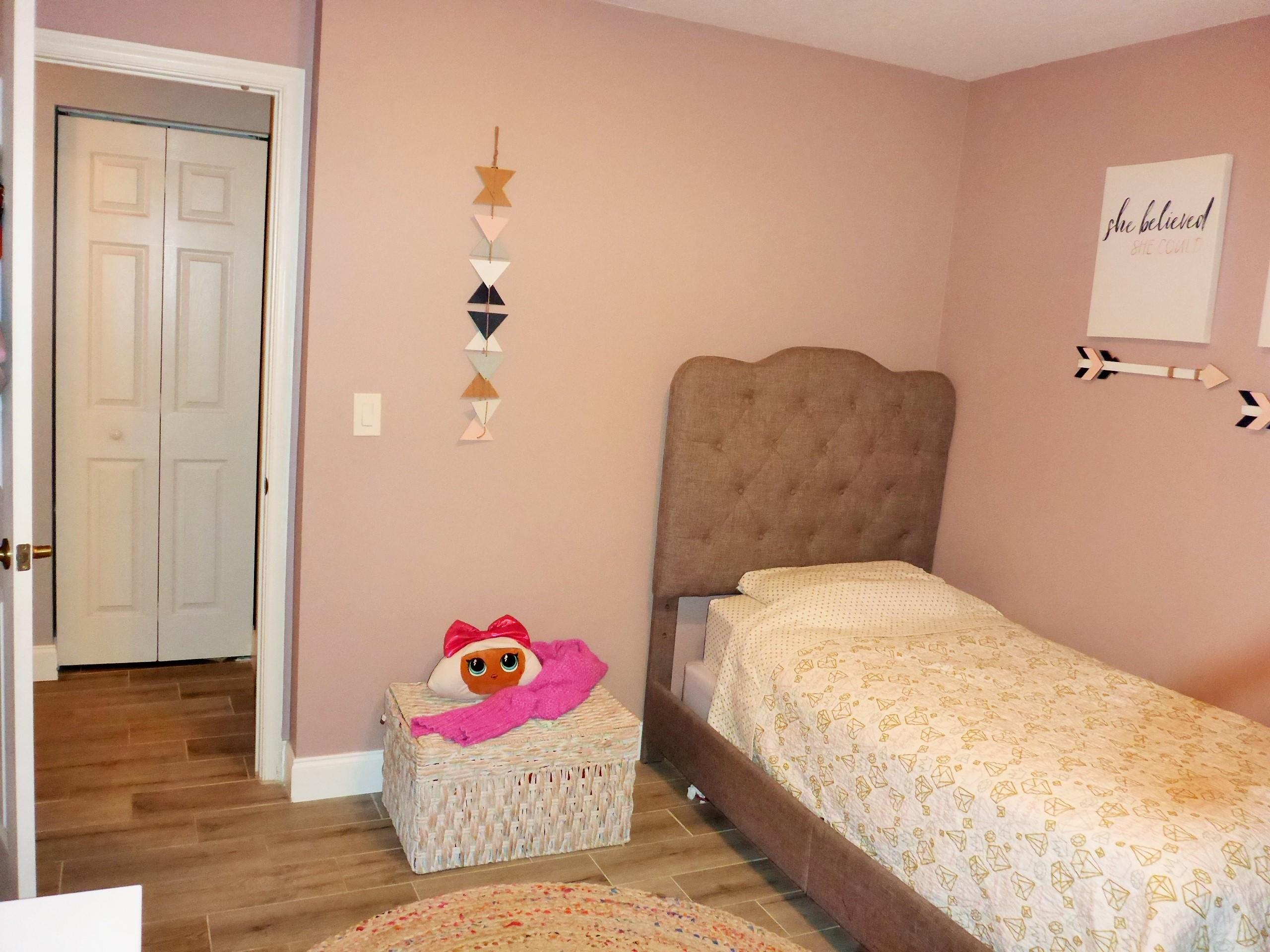 5009 Elpine Way Riviera Beach, FL 33418 - Photo 32 of 41 a bedroom with a bed and wooden floor