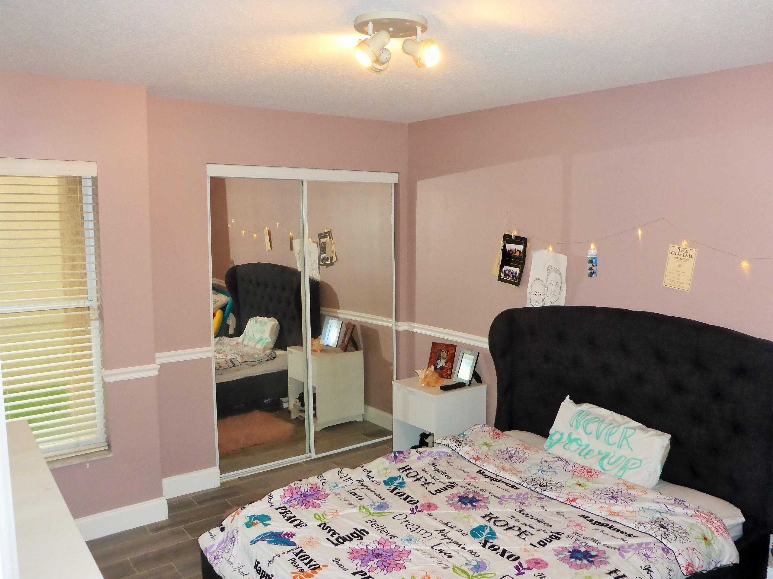 5009 Elpine Way Riviera Beach, FL 33418 - Photo 33 of 41 a bedroom with a bed and wooden floor