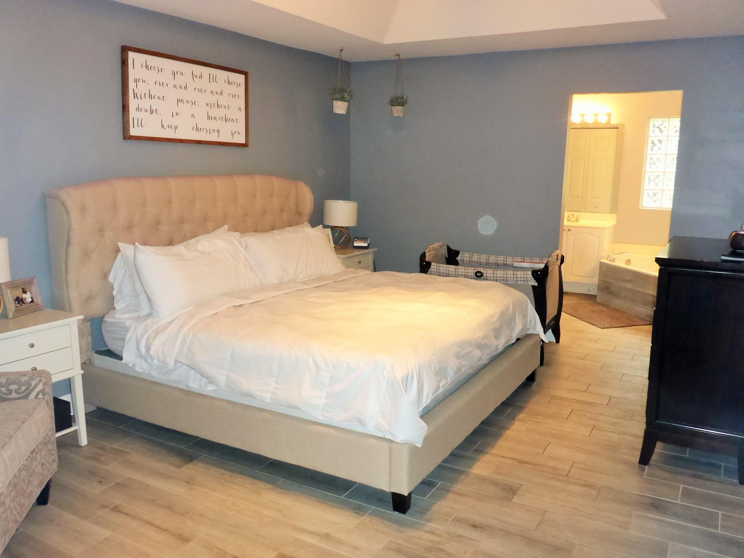 5009 Elpine Way Riviera Beach, FL 33418 - Photo 35 of 41 a large bed sitting in a bedroom next to a window