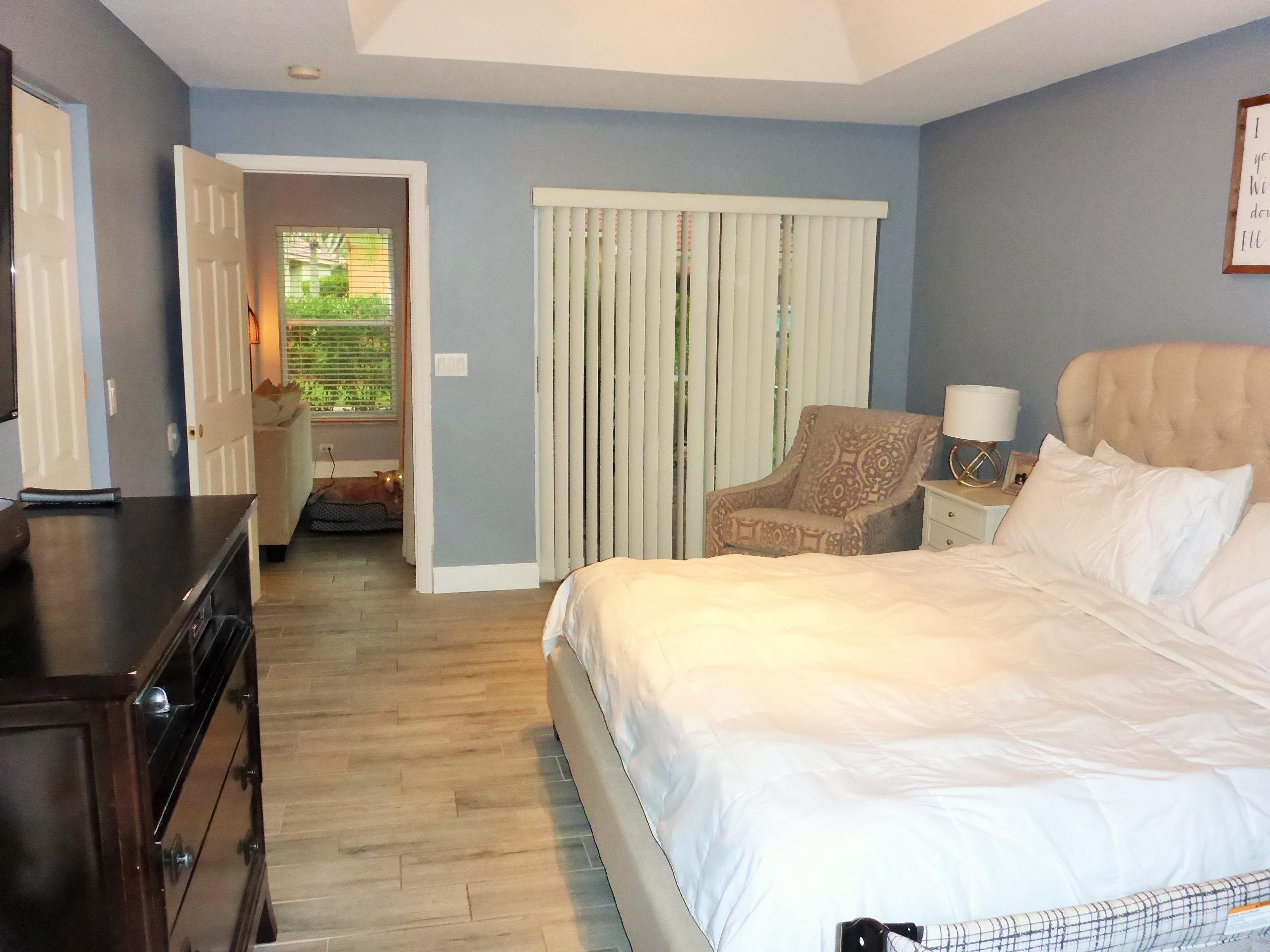5009 Elpine Way Riviera Beach, FL 33418 - Photo 36 of 41 a bedroom with a bed and wooden floor