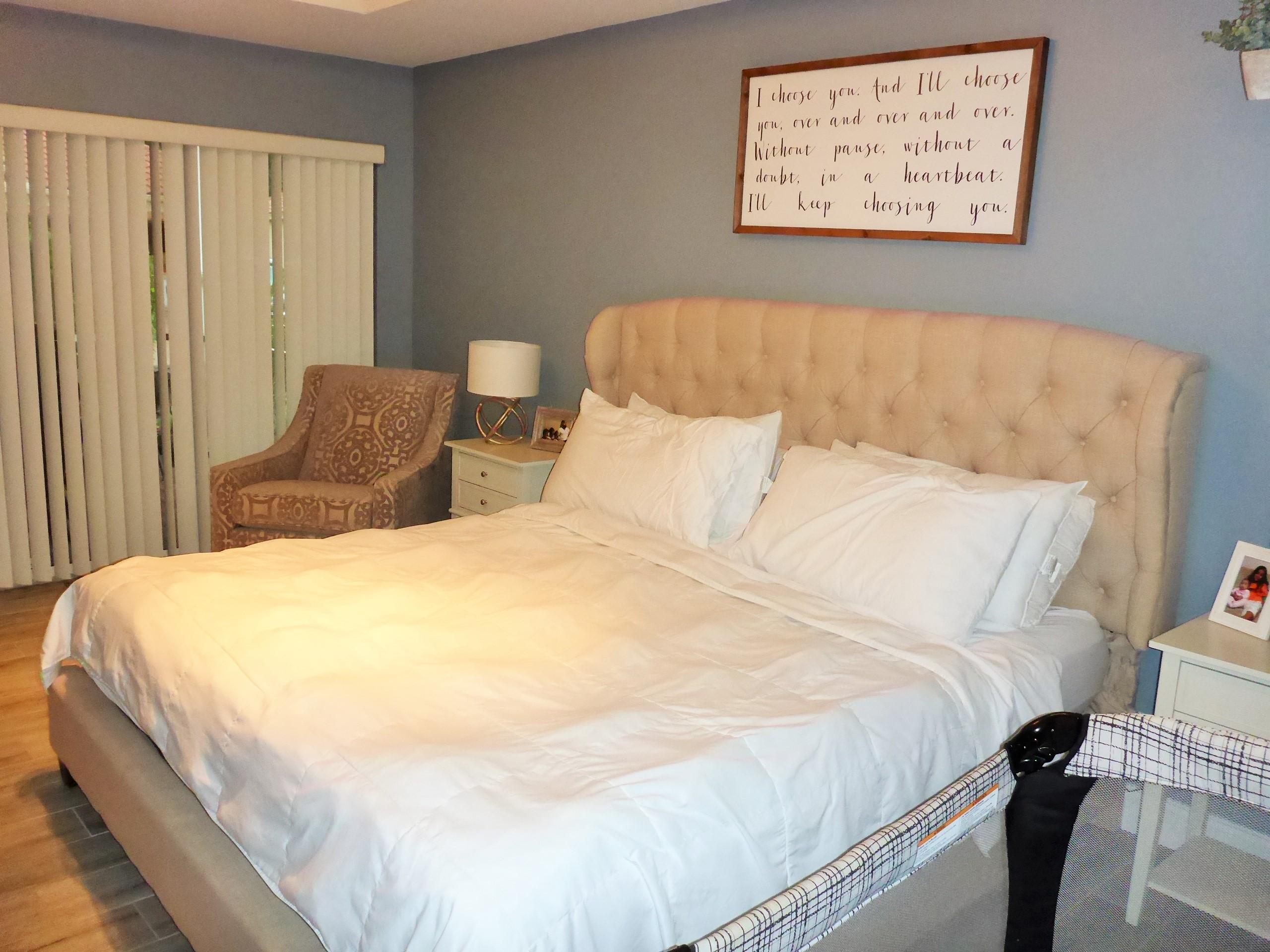 5009 Elpine Way Riviera Beach, FL 33418 - Photo 37 of 41 a large bed sitting in a bedroom next to a window