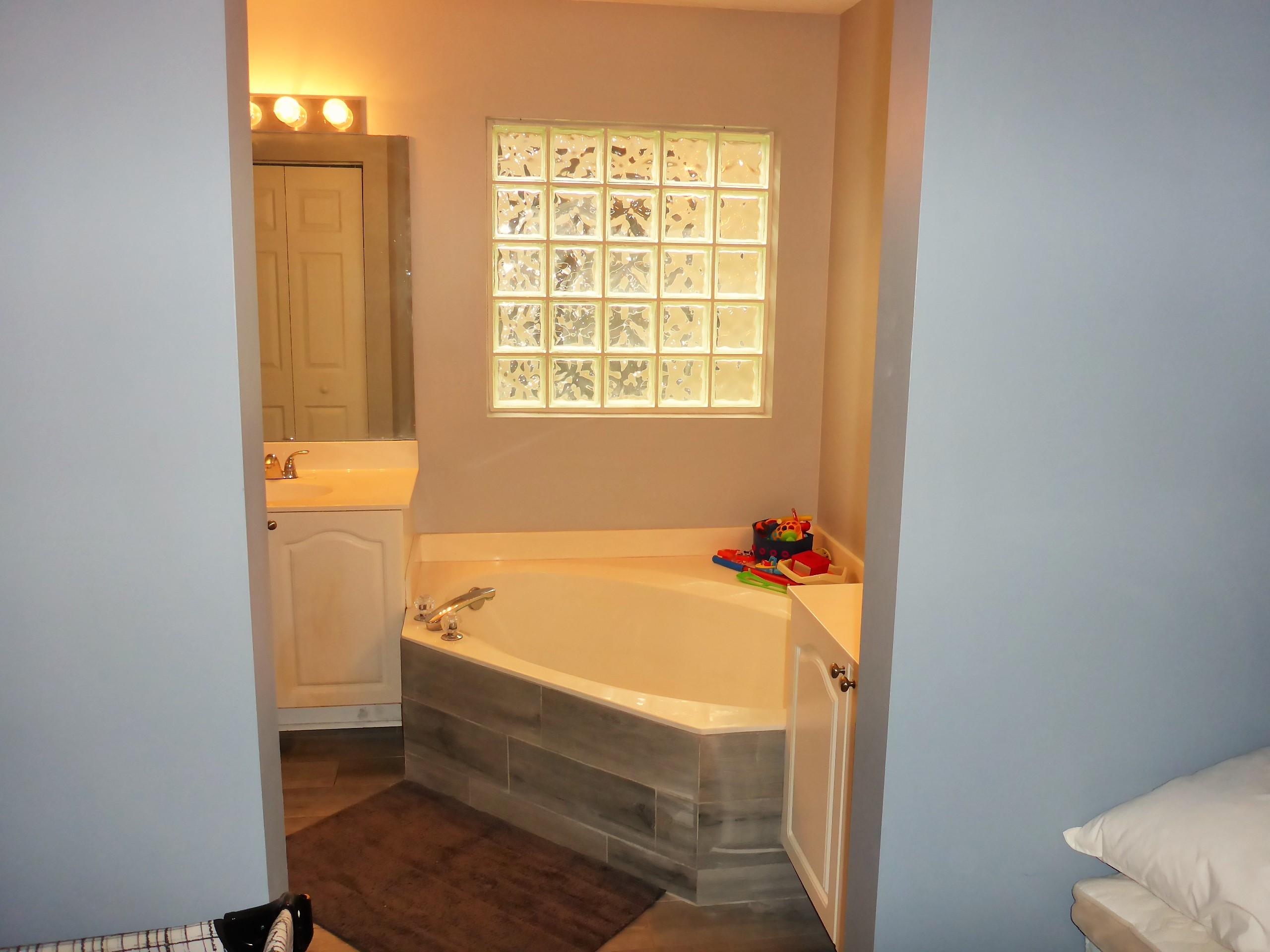 5009 Elpine Way Riviera Beach, FL 33418 - Photo 38 of 41 a bathroom with a tub and a window