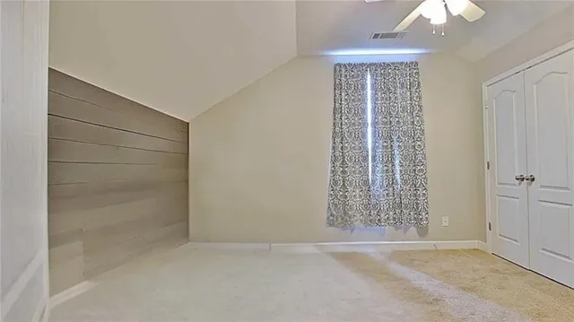 an empty room with windows and closet