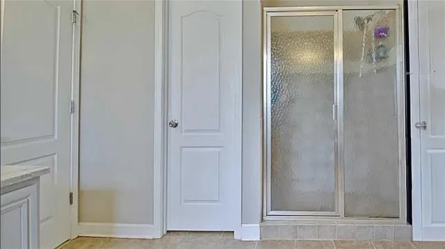 a bathroom with a granite countertop sink a toilet a mirror and shower