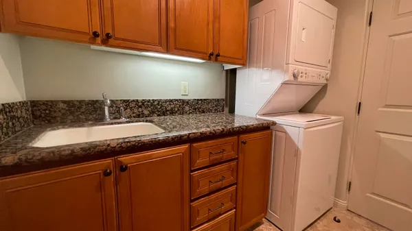 a kitchen with granite countertop cabinets and black appliances