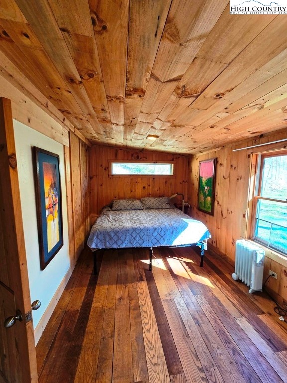 115 Little Horse Path Lansing, NC 28643 - Photo 20 of 33 a bedroom with wooden floors and large windows