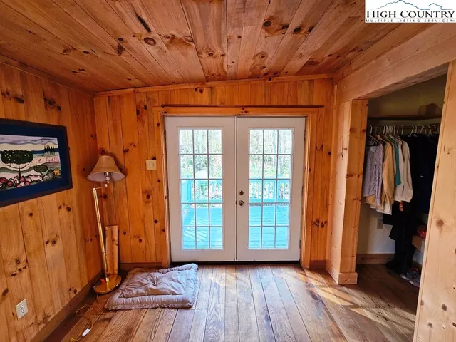 a view of a backyard with a small cabin and a chair