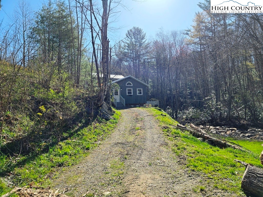 115 Little Horse Path Lansing, NC 28643 - Photo 3 of 33 a view of swimming pool with a yard and trees