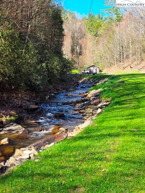 115 Little Horse Path Lansing, NC 28643 - Photo 4 of 33 a backyard of a house with lots of green space