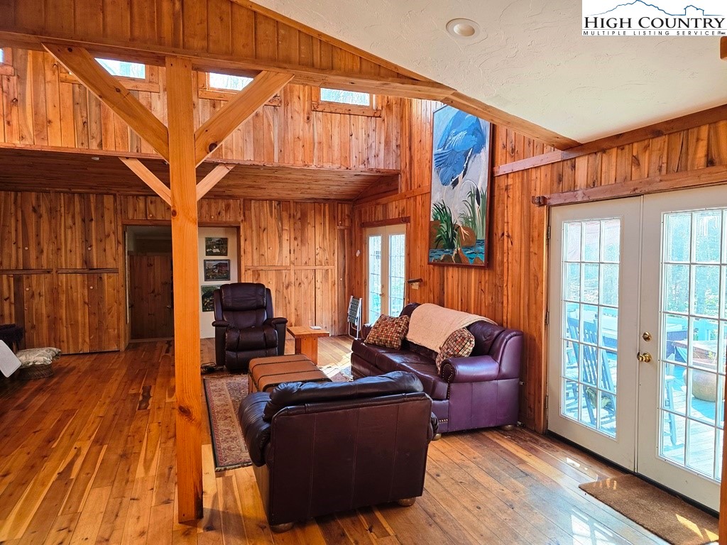 115 Little Horse Path Lansing, NC 28643 - Photo 8 of 33 a living room with furniture a wooden floor and a window