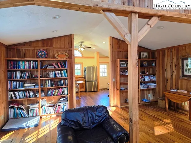 a living room with furniture and a book shelf