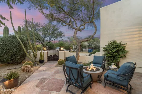 a view of a patio with couches table and chairs and potted plants