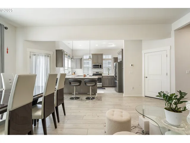 a dining room with kitchen island furniture a chandelier and kitchen view