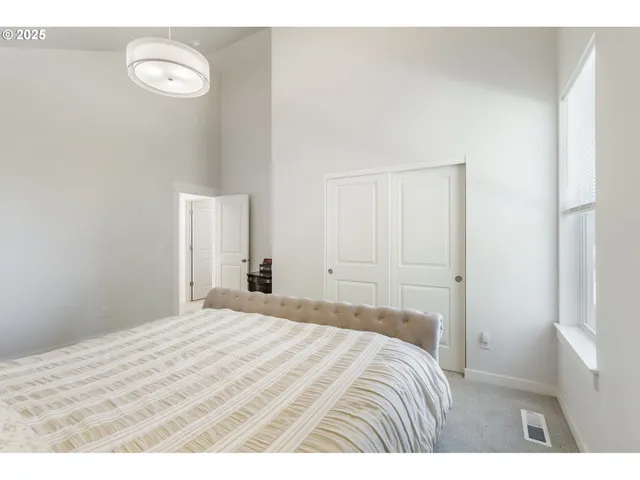 a bedroom with a bed and a painting