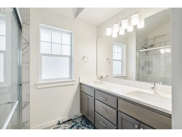 a bathroom with a sink a mirror and a shower