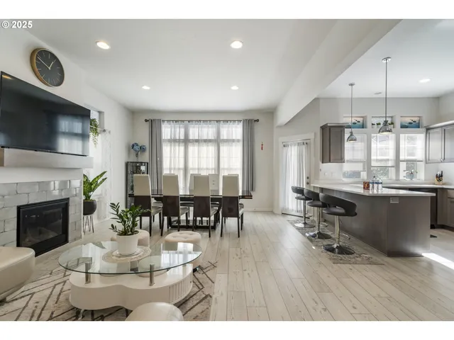 a dining room with furniture a fireplace and wooden floor