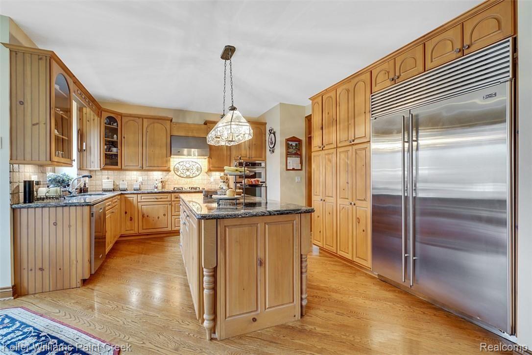 525 Sheldon Court Rochester, MI 48306 - Photo 21 of 66 A true chef's Kitchen with a Sub Zero Stainless Steel Refrigerator, Stainless Steel Double Oven, Dishwasher, Gas Range and Hood.