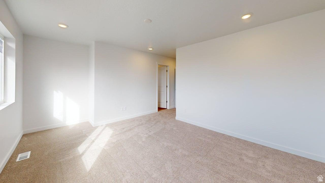 783 Pheasantbrook Drive, Unit 2A Centerville, UT 84014 - Photo 13 of 41 Spacious room featuring neutral carpeting, white walls, recessed ceiling lighting, and a white-trimmed window
