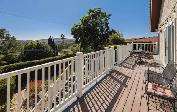a view of a patio with table and chairs and potted plants