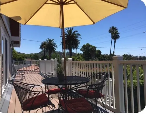 a view of a chair and table in backyard of the house