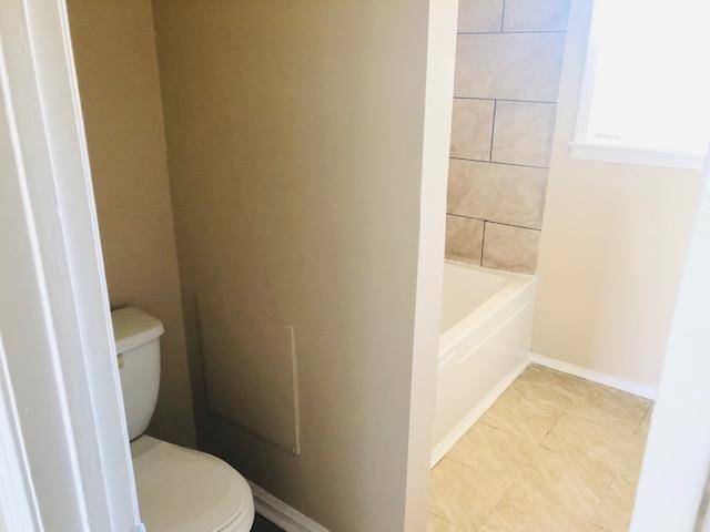 1179 Sanford Road Covington, TN 38019 - Photo 14 of 24 a white toilet sitting next to a white tub