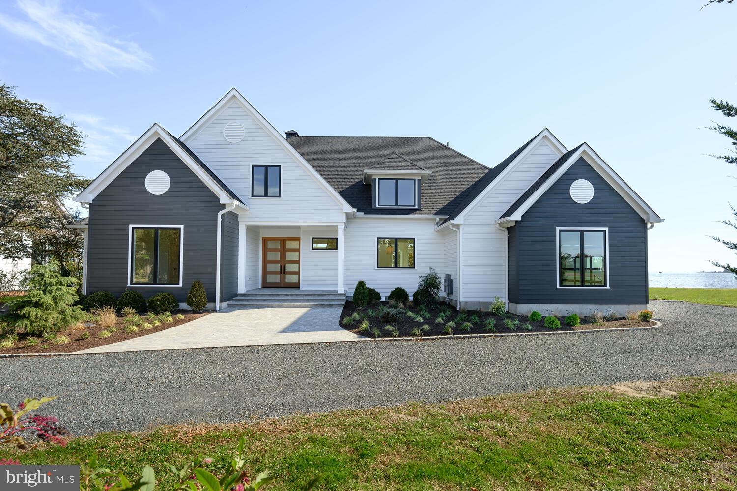 21485 Island Club Road Tilghman, MD 21671 - Photo 2 of 83 a front view of a house with a yard