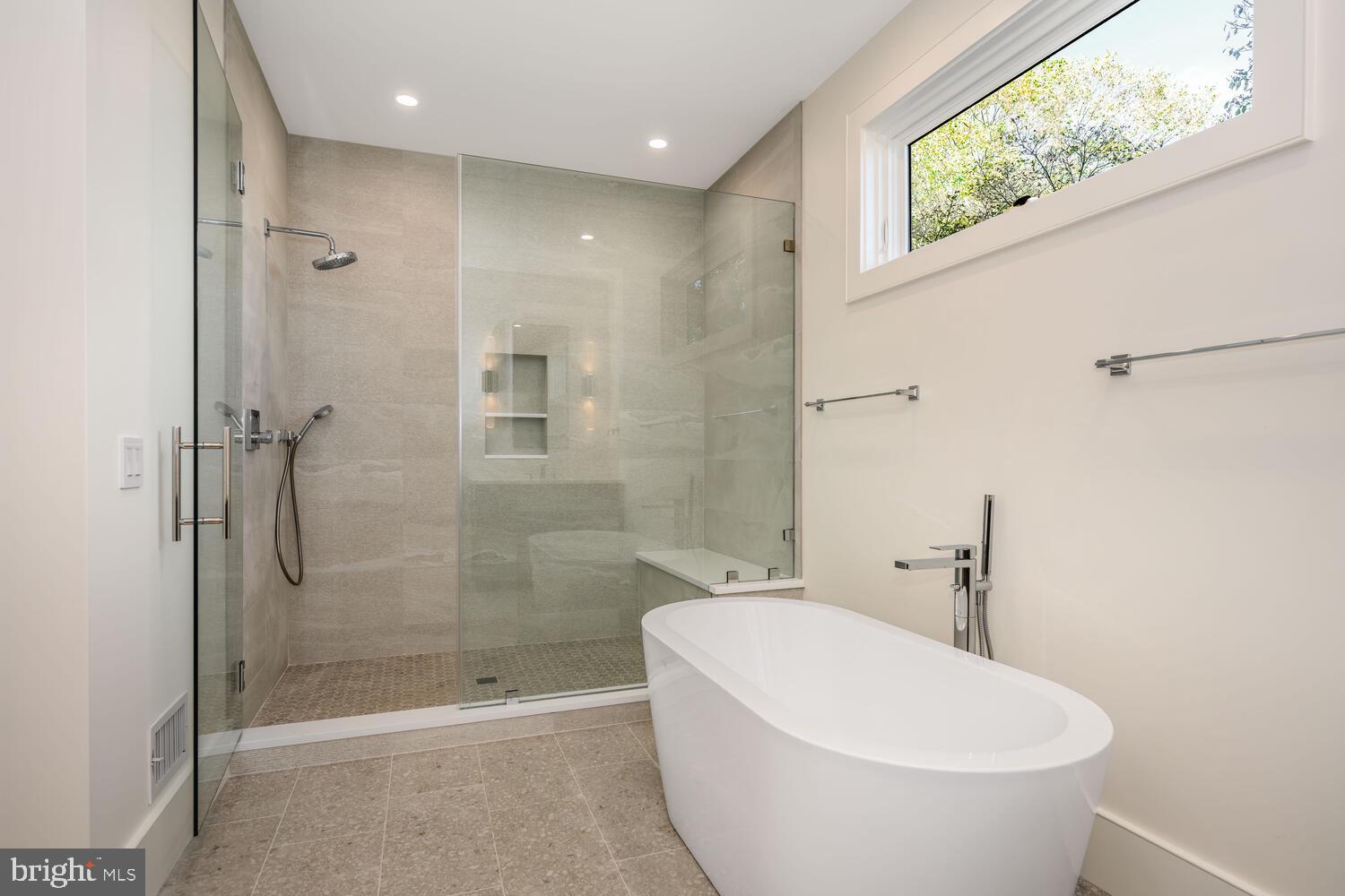21485 Island Club Road Tilghman, MD 21671 - Photo 28 of 83 a bathroom with a white bath tub a shower and a sink