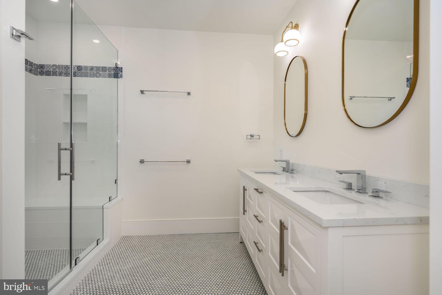 21485 Island Club Road Tilghman, MD 21671 - Photo 36 of 83 a bathroom with a double vanity sink mirror and a shower