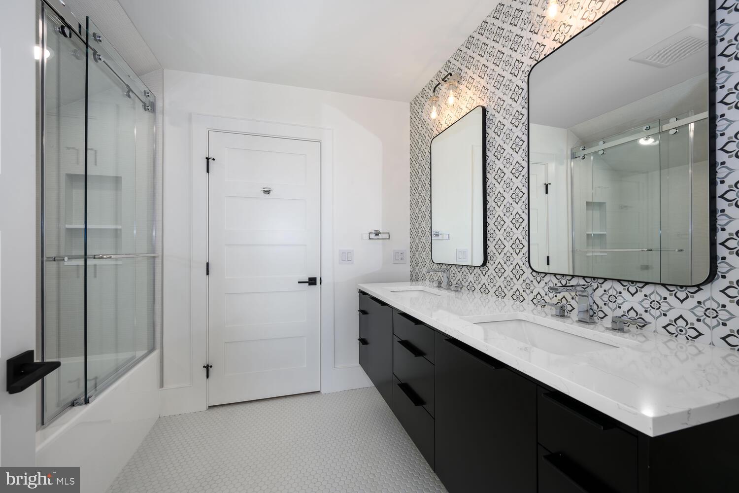 21485 Island Club Road Tilghman, MD 21671 - Photo 44 of 83 a bathroom with a double vanity sink mirror and shower