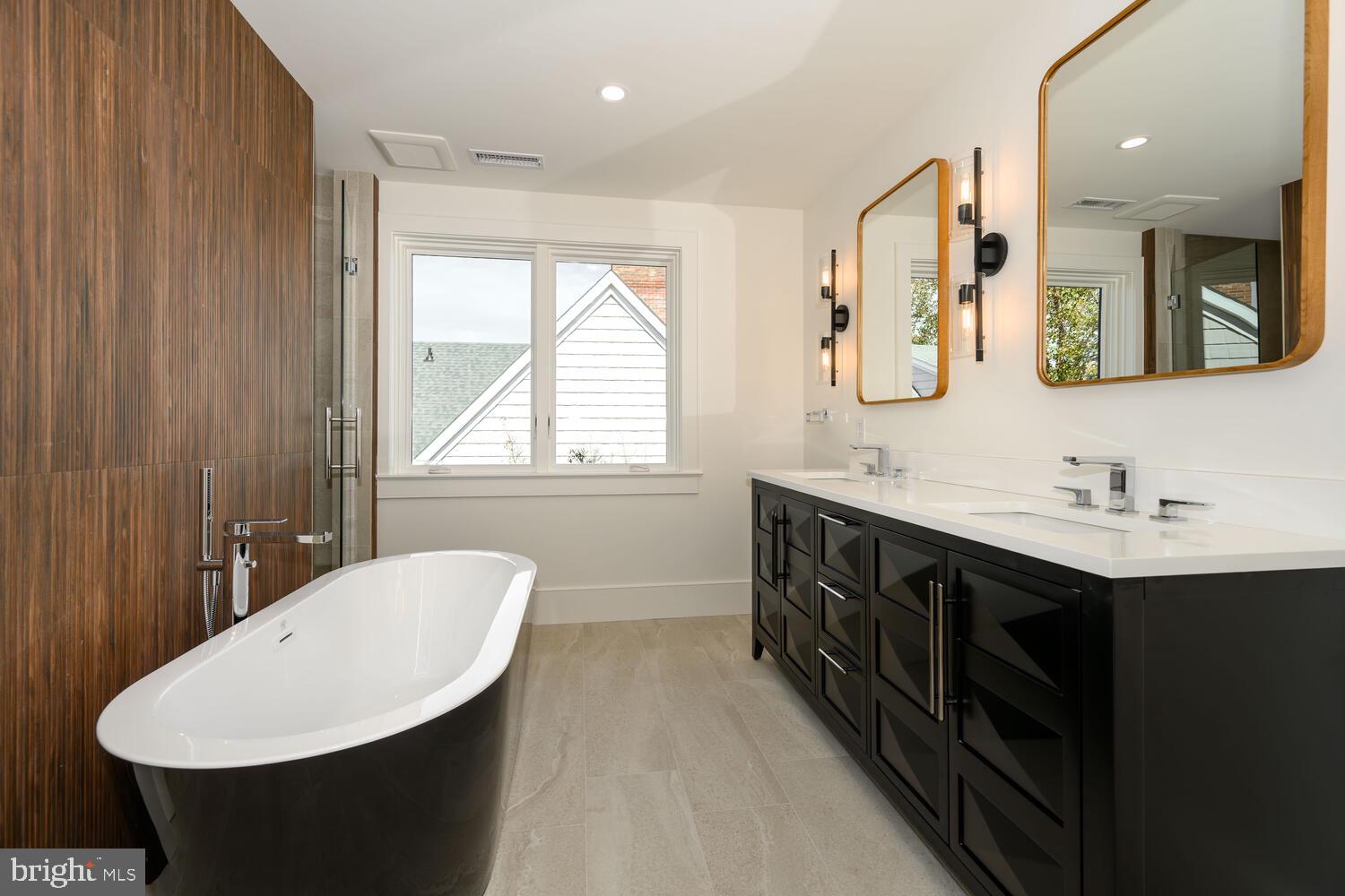 21485 Island Club Road Tilghman, MD 21671 - Photo 53 of 83 a bathroom with a double vanity sink a mirror and a bathtub