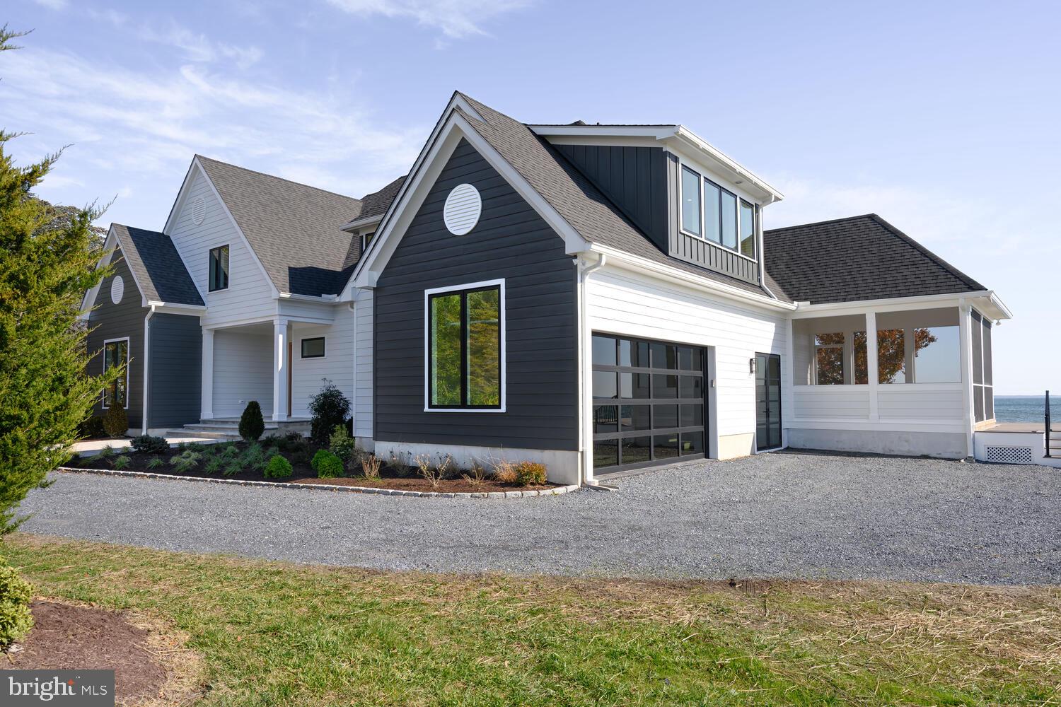 21485 Island Club Road Tilghman, MD 21671 - Photo 65 of 83 a front view of a house with a yard and garage