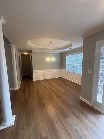 a view of a room with window and wooden floor