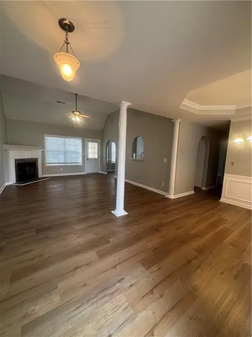 a view of an empty room and wooden floor