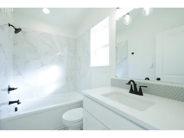 a bathroom with a sink a toilet a tub and a shower