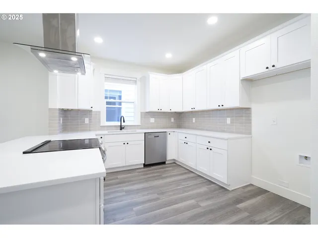 a kitchen with a sink white cabinets and white appliances