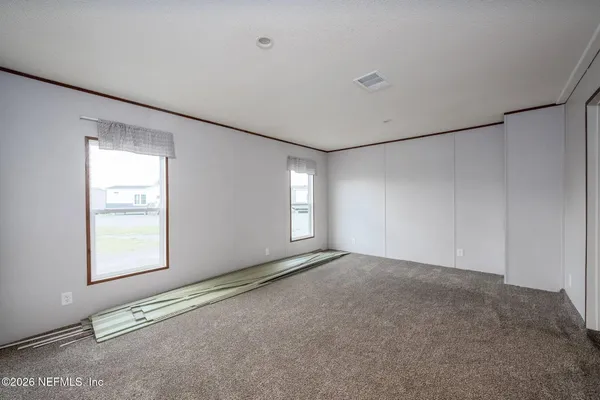 a view of an empty room with windows