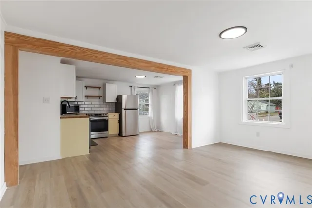 a kitchen with a stove a refrigerator and a sink