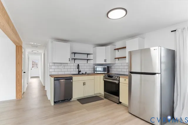 a view of a dining room with furniture and a potted plant