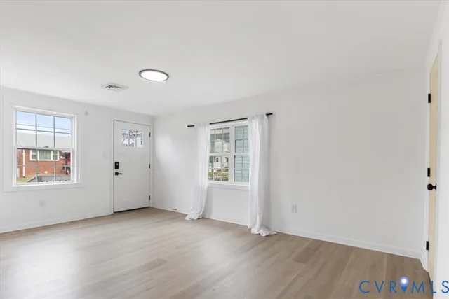 a view of kitchen with wooden floor and electronic appliances