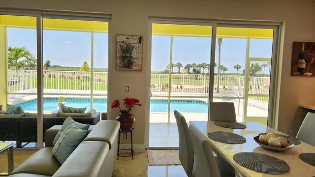 a living room with furniture and a floor to ceiling window