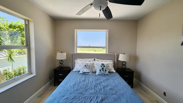 a view of a house with a flower plants and wooden fence