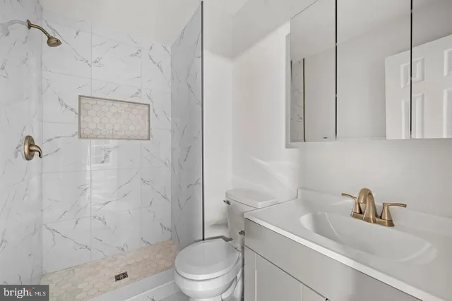 a bathroom with a sink toilet and shower