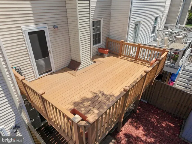 a view of a house with a wooden deck
