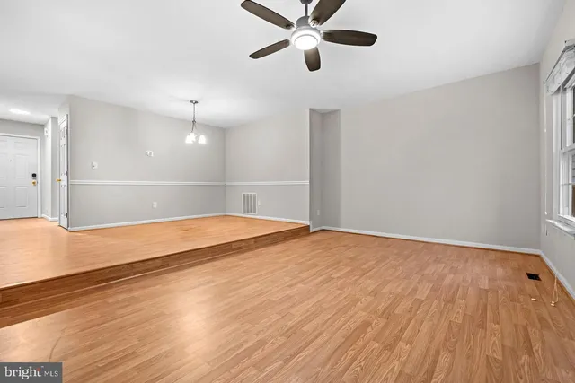 a view of an empty room and wooden floor