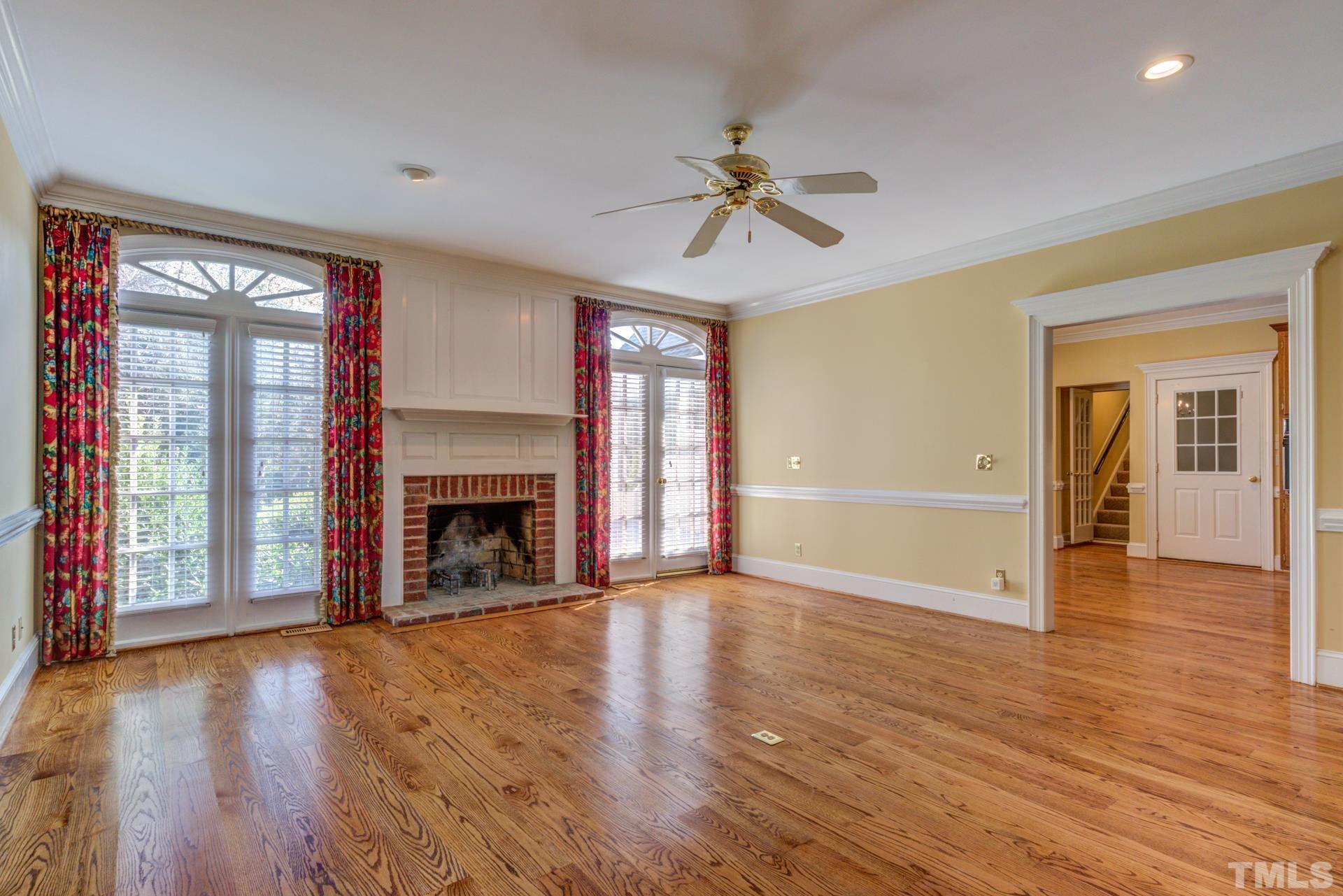 1900 Lizard Lick Road Zebulon, NC 27597 - Photo 17 of 84 a view of a livingroom with wooden floor a fireplace and window