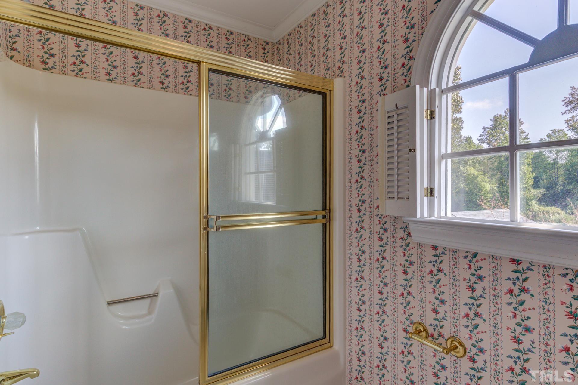 1900 Lizard Lick Road Zebulon, NC 27597 - Photo 46 of 84 a bathroom with a glass shower door