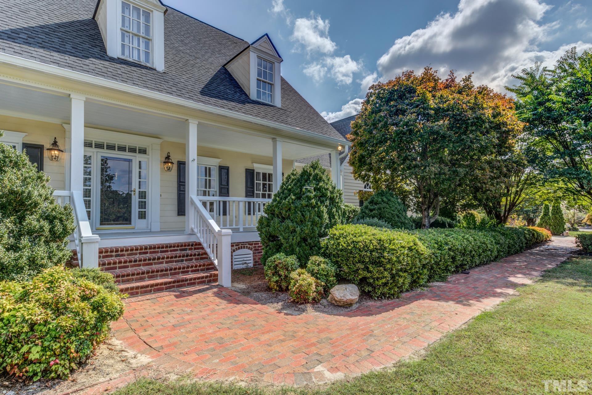 1900 Lizard Lick Road Zebulon, NC 27597 - Photo 78 of 84 a view of a house with potted plants and a bench